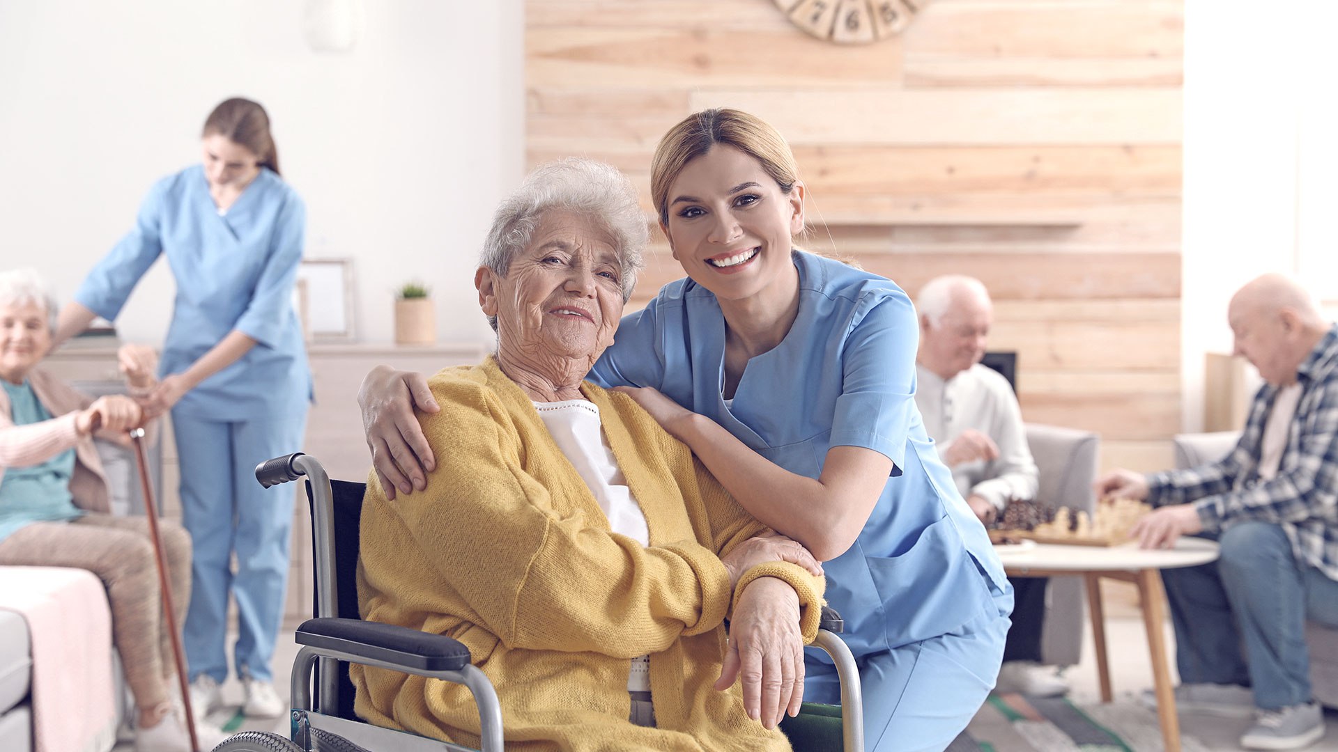 A nurse from an international background, in a community nurse uniform, visits an elderly patient at home, checking their health with a warm smile