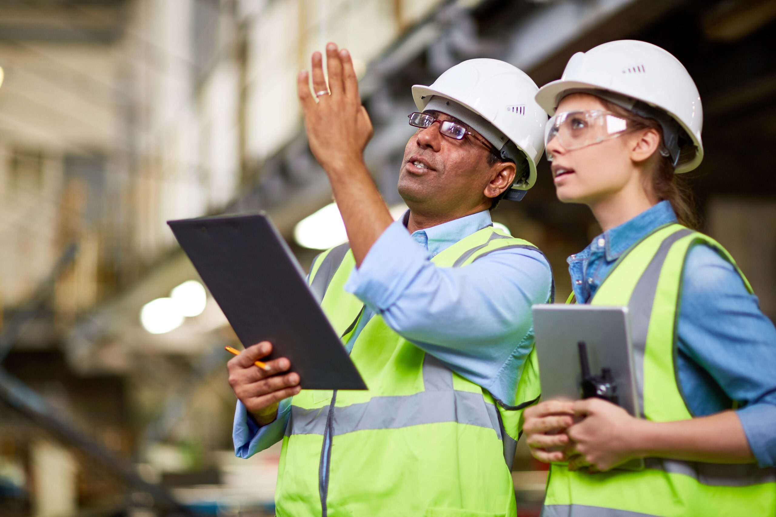 An engineer from an international background, in a hard hat, inspects equipment at a mining site in Western Australia
