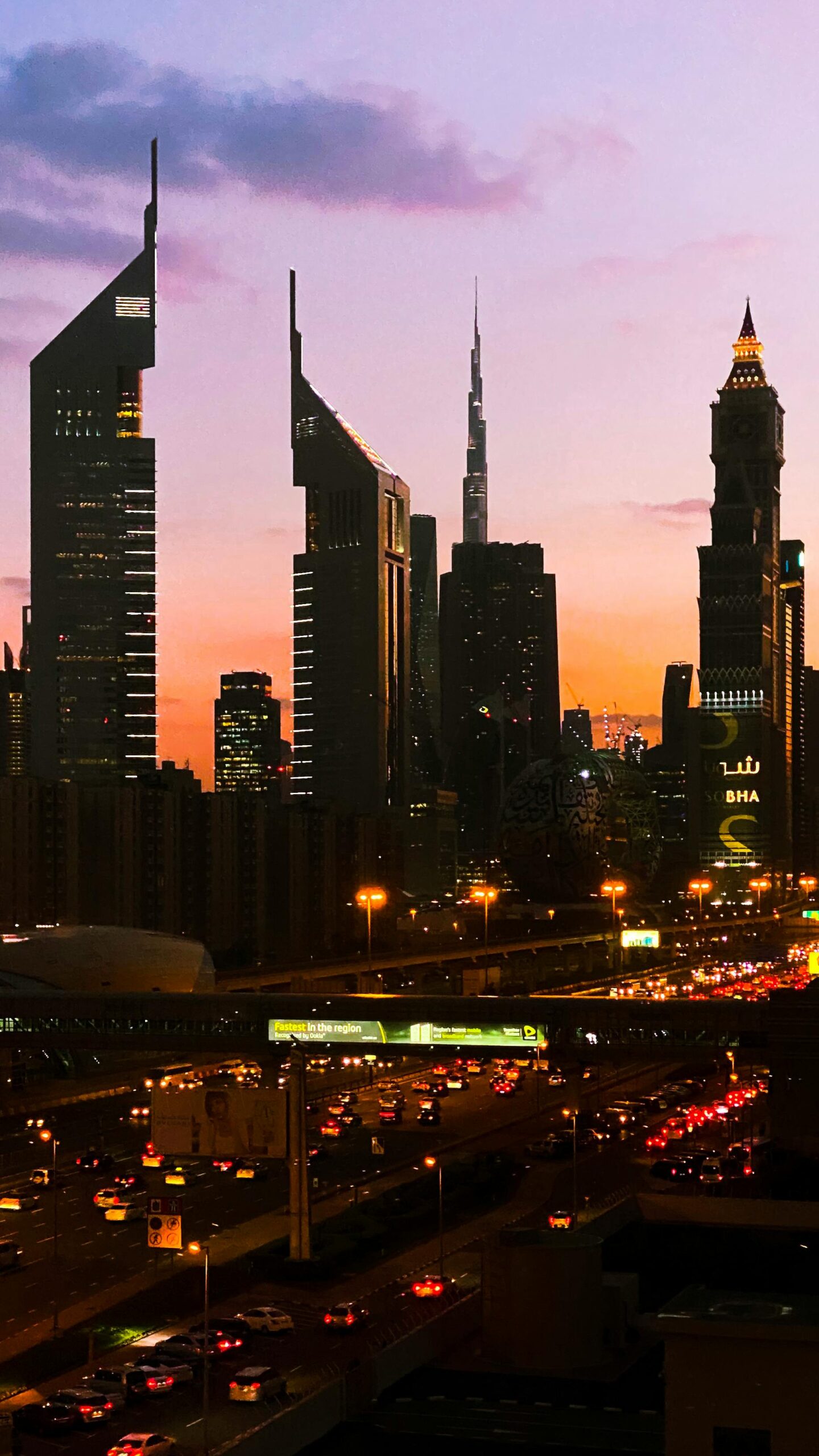 A vibrant Dubai skyline at sunset, showcasing modern architecture.